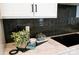 Kitchen countertop with dark tile backsplash and modern appliances at 8008 Cedarsmith Ct, Charlotte, NC 28217