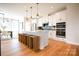 Modern kitchen with island, stainless steel appliances, and hardwood floors at 8008 Cedarsmith Ct, Charlotte, NC 28217