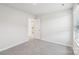 Clean bedroom with neutral walls, carpet, and an open door leading to the kitchen at 827 Blue Canyon Dr, York, SC 29745
