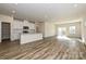 Open-concept living area with modern kitchen, stainless appliances, island, and wood-look floors at 827 Blue Canyon Dr, York, SC 29745