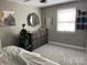 Cozy bedroom featuring a dresser and a Christmas tree at 8905 Vagabond Rd, Charlotte, NC 28227