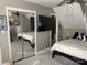 Bright bedroom with mirrored closet doors and large bed at 8905 Vagabond Rd, Charlotte, NC 28227