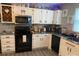 Modern kitchen with white cabinets and granite counters at 8905 Vagabond Rd, Charlotte, NC 28227