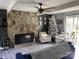 Spacious living room featuring a stone fireplace, ceiling fan, and natural light at 8905 Vagabond Rd, Charlotte, NC 28227