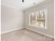 Bright bedroom with window and neutral color scheme at 9042 Summer Club Rd, Charlotte, NC 28277