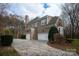 Brick house with two-car garage and landscaping at 9042 Summer Club Rd, Charlotte, NC 28277