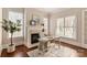 Bright home office featuring a fireplace, built-in shelving, and large windows at 9042 Summer Club Rd, Charlotte, NC 28277