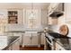 Modern kitchen with white cabinets, granite countertops, and a farmhouse sink at 9042 Summer Club Rd, Charlotte, NC 28277