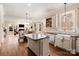 Open concept kitchen with large island and views into adjacent living space at 9042 Summer Club Rd, Charlotte, NC 28277