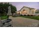 Backyard with patio and deck at dusk at 1108 Butterburr Dr, Matthews, NC 28104