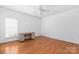 Bright bedroom featuring hardwood floors and a ceiling fan at 1108 Butterburr Dr, Matthews, NC 28104