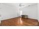 Bright bedroom featuring hardwood floors and a ceiling fan at 1108 Butterburr Dr, Matthews, NC 28104