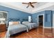 Spacious bedroom with two twin beds, hardwood floors, and ceiling fan at 1108 Butterburr Dr, Matthews, NC 28104