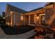 Evening view of brick home with landscaped yard and walkway at 1108 Butterburr Dr, Matthews, NC 28104