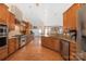 Spacious kitchen with island, stainless steel appliances, and hardwood floors at 1108 Butterburr Dr, Matthews, NC 28104