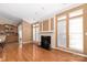 Living room with hardwood floors, fireplace, and large windows at 1108 Butterburr Dr, Matthews, NC 28104