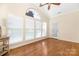 Sunroom featuring hardwood floors, arched window, and French door at 1108 Butterburr Dr, Matthews, NC 28104