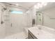 Bathroom with marble shower, single vanity, and window at 12024 John Newton Dr # 41, Davidson, NC 28036