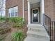 Brick front exterior with black front door and steps at 12024 John Newton Dr # 41, Davidson, NC 28036