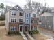 Three-story brick townhome with tan and blue siding, and a front walkway at 12024 John Newton Dr # 41, Davidson, NC 28036