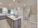 Island kitchen with gray cabinets, white countertops and pendant lighting at 12024 John Newton Dr # 41, Davidson, NC 28036