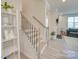 Modern staircase with white risers and black metal balusters at 12024 John Newton Dr # 41, Davidson, NC 28036