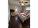 Cozy bedroom with dark hardwood floors, ceiling fan, and ample closet space at 1206 N Boyce St, Gastonia, NC 28052