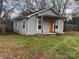 Gray siding house with orange front door, small front porch, and a yard at 1206 N Boyce St, Gastonia, NC 28052