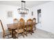 Bright dining room features a wood table with six chairs and a modern chandelier at 1226 Twin Lakes Rd, Rock Hill, SC 29732