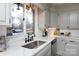 Bright kitchen with white quartz countertops, gray cabinets, and a farmhouse sink at 1226 Twin Lakes Rd, Rock Hill, SC 29732