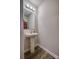 Clean bathroom with pedestal sink, mirror, and wood-look flooring at 136 Jo Creek Ln, Harmony, NC 28634