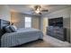 Spacious bedroom with a ceiling fan, large TV, and ensuite bathroom access at 136 Jo Creek Ln, Harmony, NC 28634