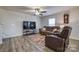 Living room with hardwood floors, brown leather sectional and accent rug at 136 Jo Creek Ln, Harmony, NC 28634