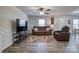 Spacious living room with hardwood floors, a brown sectional sofa and a large TV at 136 Jo Creek Ln, Harmony, NC 28634