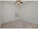 Simple bedroom with ceiling fan and window with blinds at 14509 Batteliere Dr, Charlotte, NC 28278