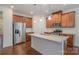 Modern kitchen with stainless steel appliances and an island at 14509 Batteliere Dr, Charlotte, NC 28278