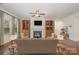 Cozy living room with fireplace, hardwood floors, and built-in wooden cabinets at 14509 Batteliere Dr, Charlotte, NC 28278