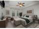 Relaxing main bedroom with tray ceiling, ceiling fan, sitting area, and neutral tones at 14509 Batteliere Dr, Charlotte, NC 28278