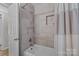 Clean bathroom with a bathtub and updated tile at 1737 Edgewater Dr, Charlotte, NC 28210