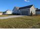 Two-car garage with a paved driveway and landscaping at 1858 Yardley St, Rock Hill, SC 29732