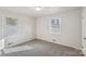 Bright bedroom featuring grey carpet and two windows with blinds at 2016 Norwich Pl, Charlotte, NC 28208