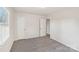 Simple bedroom with grey carpet, neutral walls and two closets at 2016 Norwich Pl, Charlotte, NC 28208