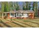 Brick ranch house featuring a covered porch and well-manicured lawn at 2016 Norwich Pl, Charlotte, NC 28208