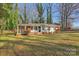 Ranch home with brick facade, covered porch, and a spacious yard at 2016 Norwich Pl, Charlotte, NC 28208