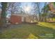 Brick ranch house with covered porch and yard at 2016 Norwich Pl, Charlotte, NC 28208