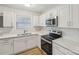 Modern kitchen with white cabinets and stainless steel appliances at 2016 Norwich Pl, Charlotte, NC 28208