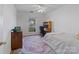 Bright bedroom with window, desk, and ceiling fan at 2532 Governors Pointe Ne Ct, Concord, NC 28025