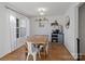 Dining area features a rustic wooden table and white chairs at 2532 Governors Pointe Ne Ct, Concord, NC 28025