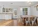 Kitchen with white cabinets, wooden table, and backyard access at 2532 Governors Pointe Ne Ct, Concord, NC 28025