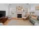 Living room boasts hardwood floors, fireplace, and a large TV at 2532 Governors Pointe Ne Ct, Concord, NC 28025